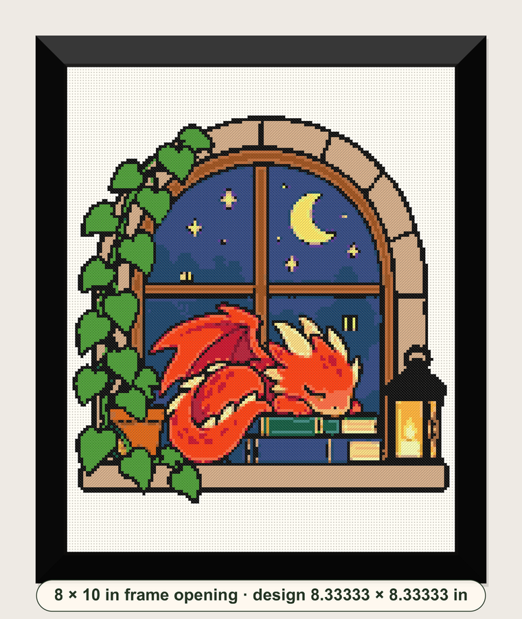Dragon on Books cross-stitch design showing a sleeping red dragon at a moonlit window in a digital black frame mockup